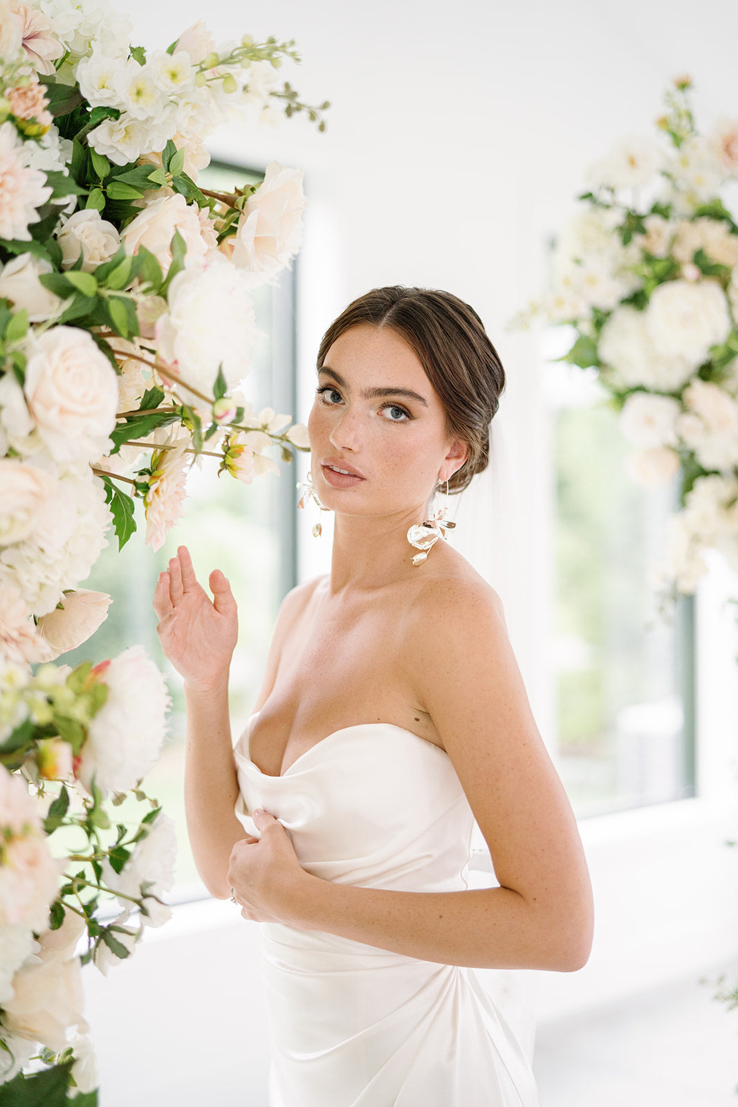 bride smelling wedding flowers
