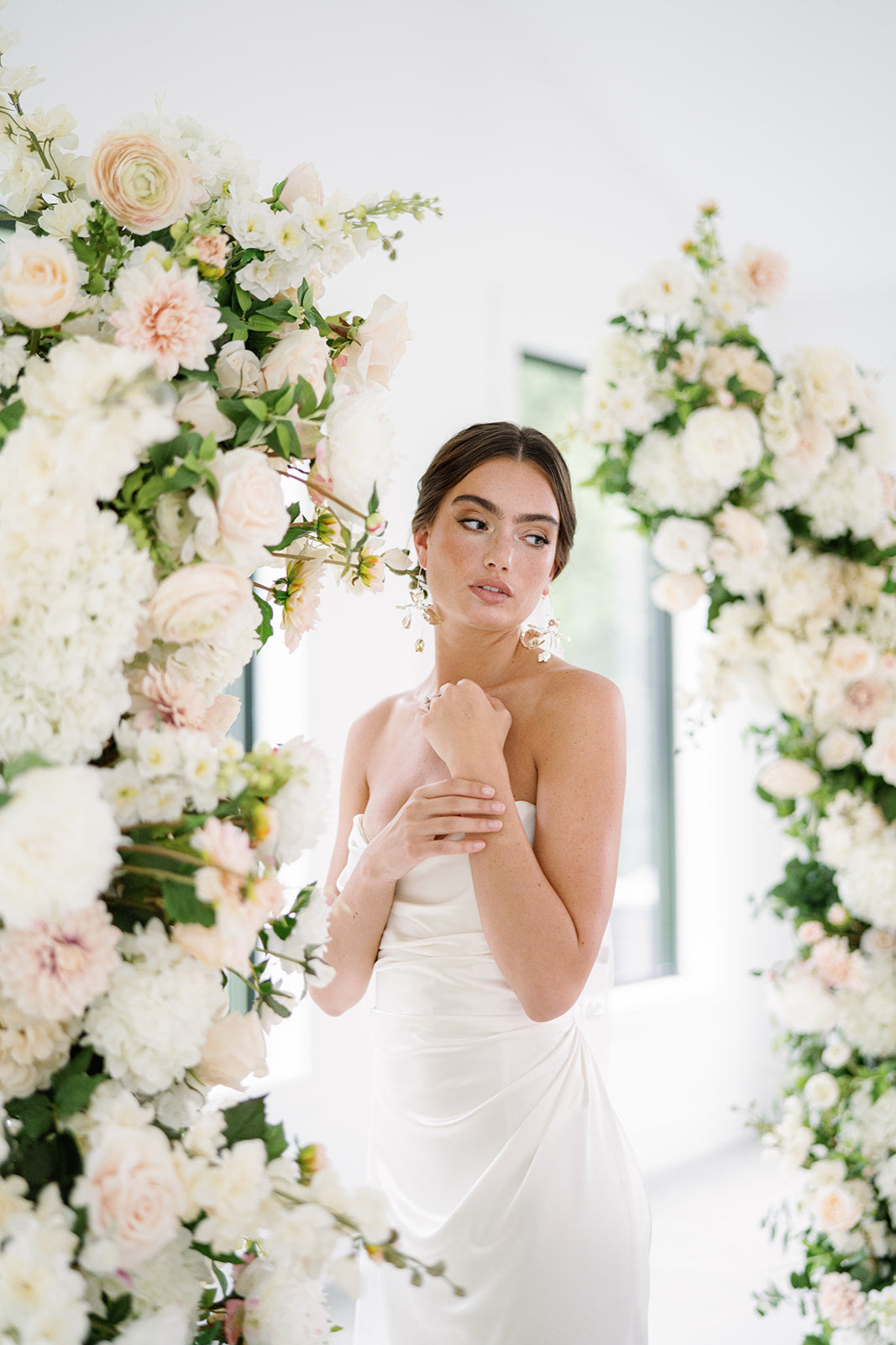 Bride in front of flowers