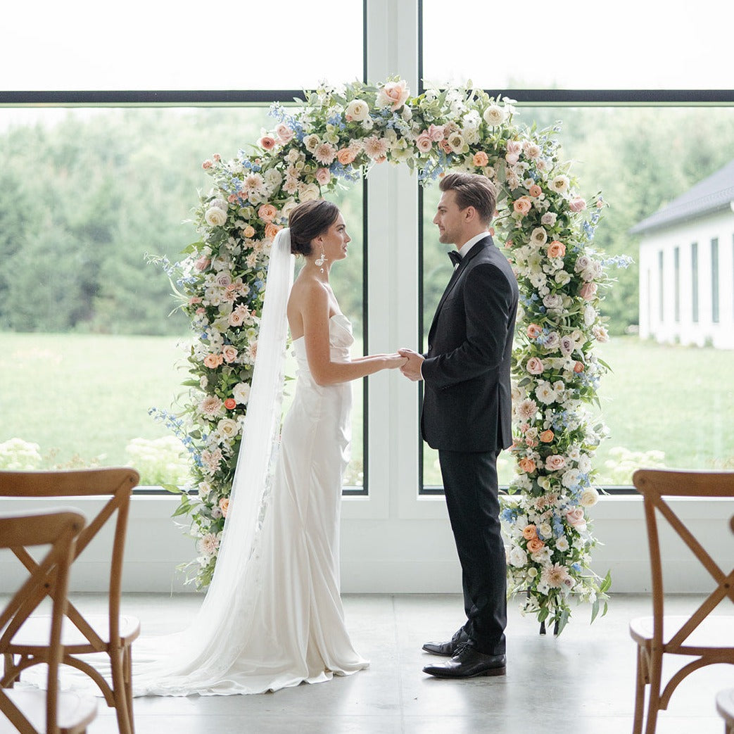 exchanging vows in front of rental arch